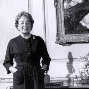 A black and white photo of Eleanor Ford standing in Ford House.
