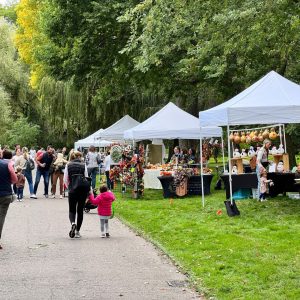 People gather along the outdoor markets at Harvest Day at Ford House. 