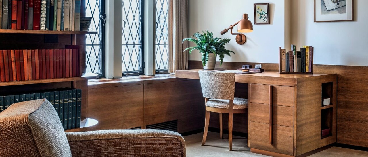 Interior photo of Ford House showing a mid-century modern desk and furnishings, promoting the Design Through the Decades guided tour.