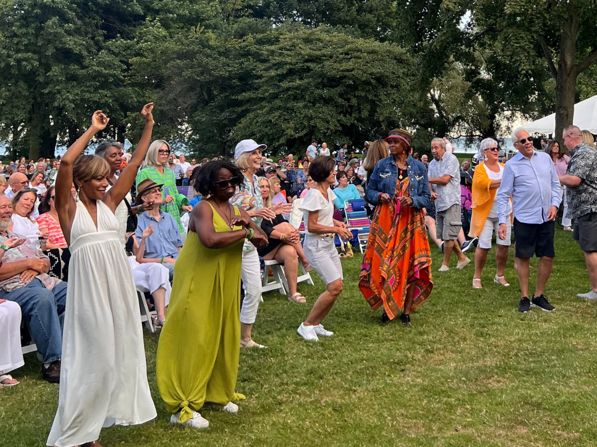 Audience members of all ages dance and smile on the lawn during The Dave Hamilton Band’s concert at Ford House.