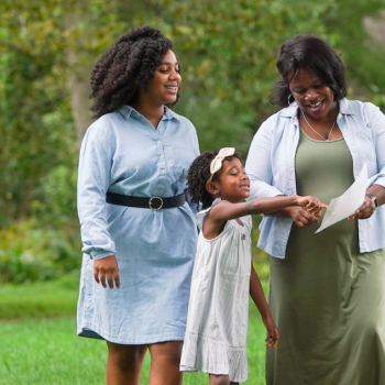 Three generations of Black women smiling as they explore the wooded trail included with Grounds Admission at Ford House.