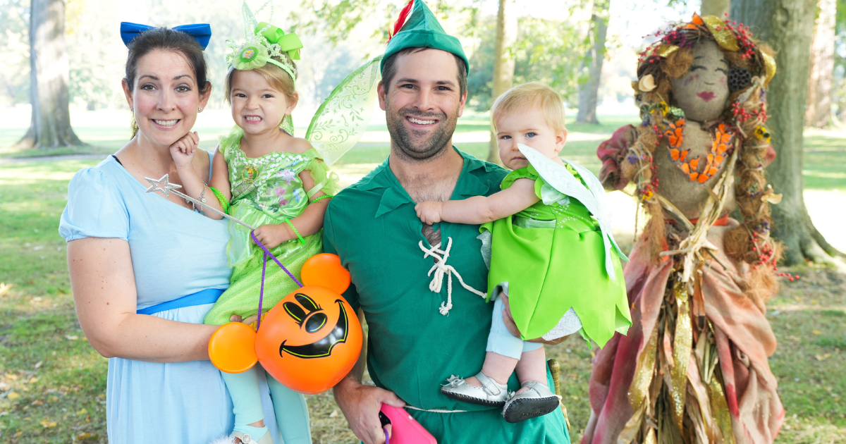A family in Peter Pan costumes smiles together during the Little Goblins Halloween event at Ford House.