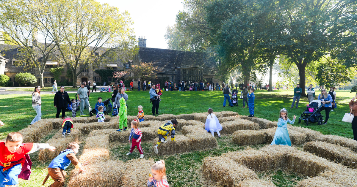 Children in costume run through a hay bale maze on the Ford House grounds during Little Goblins.